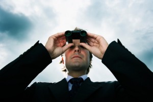 Businessman using binoculars