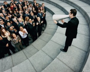 Businessman Standing on Steps Outside Talking Through a Megaphone